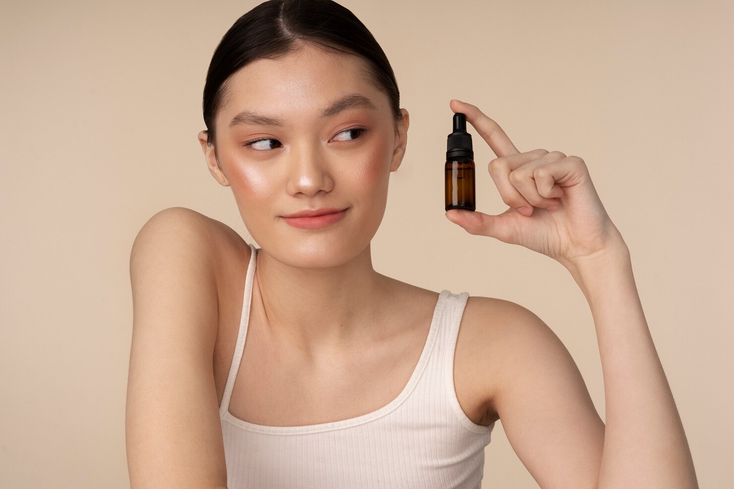 medium-shot-korean-woman-posing-with-serum-bottle_23-2150167638
